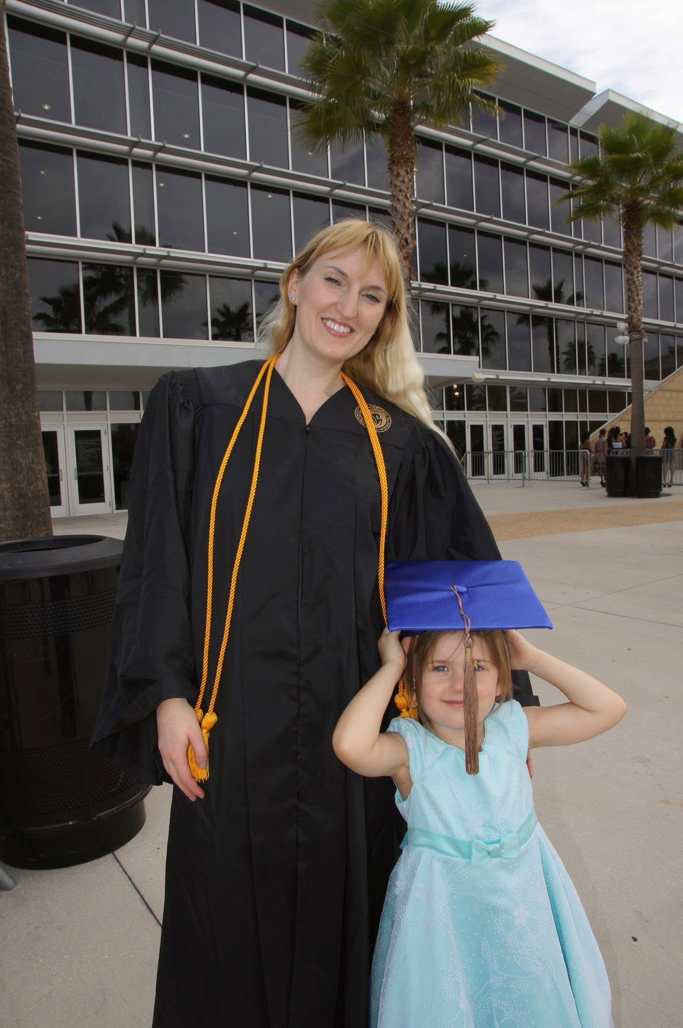 Natallia Mann graduating from the University of Central Florida in 2012, magna cum laude, with her daughter